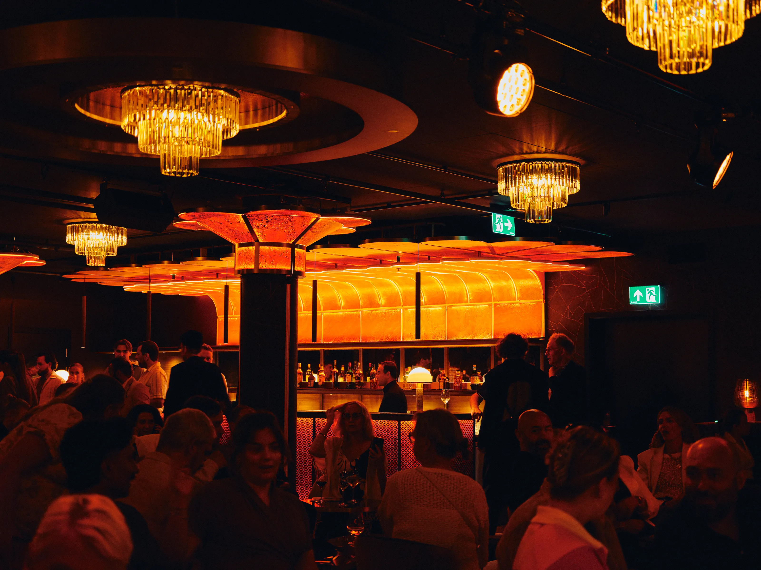 Live music performance in a warmly lit restaurant space with an audience around the tables
